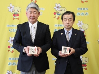 納豆を手にした高丸社長と市長